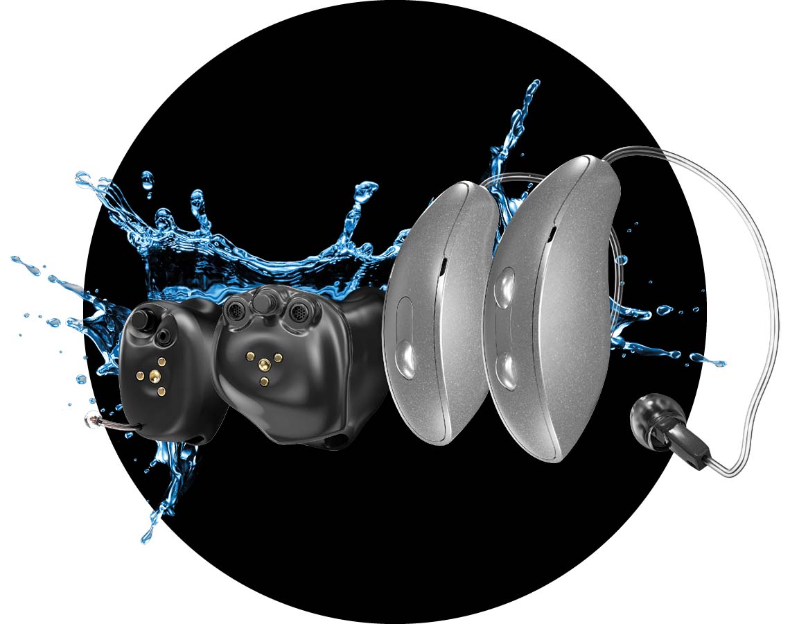 A variety of hearing aid styles being splashed with water