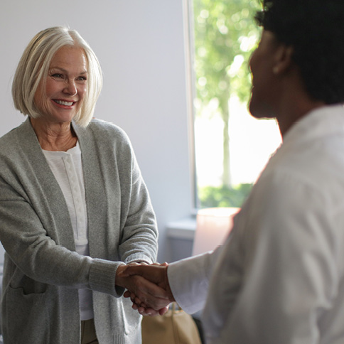 two women shaking hands