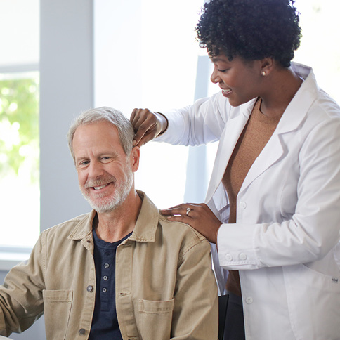 Man being fit with a hearing aid